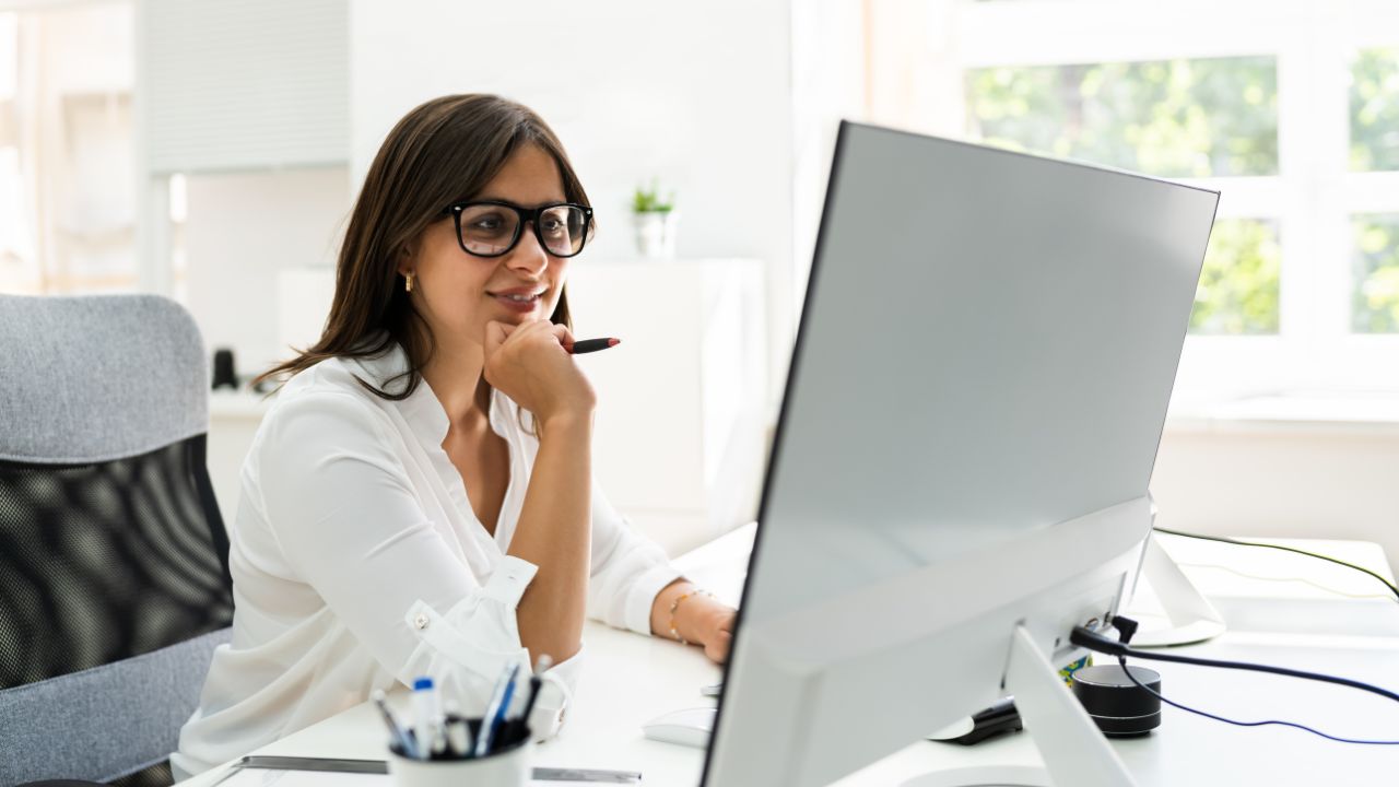 An executive working in her office on her computer | Scott Legal, P.C. An executive working in her office on her computer