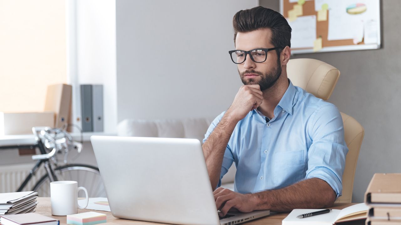 A man working on his laptop from his desk | Scott Legal, P.C. A man working on his laptop from his desk