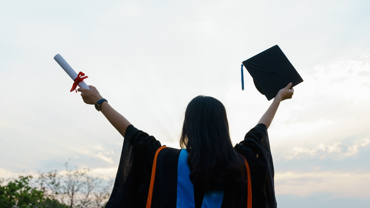 A University student in a cap and gown | Scott Legal, P.C. A University student in a cap and gown