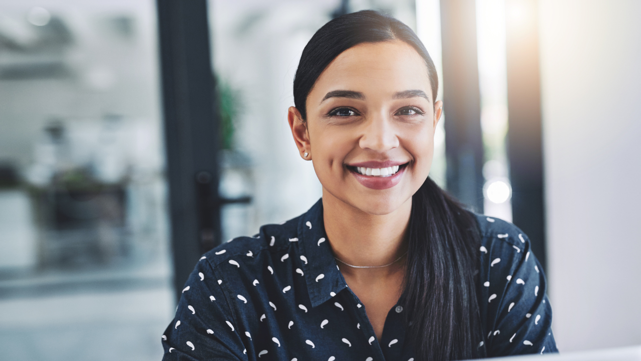 A woman smiling at her most recent approval | Scott Legal, P.C. A woman smiling at her most recent approval
