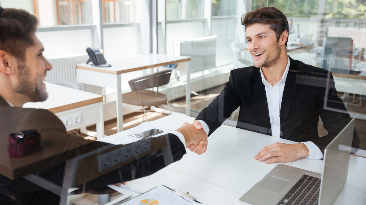 Two men meeting in an office, shaking hands | Scott Legal, P.C. Two men meeting in an office, shaking hands