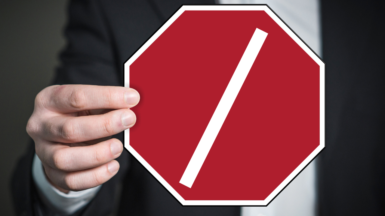 A man holding a stop sign | Scott Legal, P.C. A man holding a stop sign