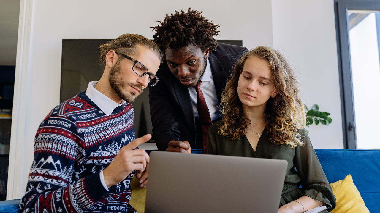 3 people gathered around a computer, looking at information | Scott Legal, P.C. 3 people gathered around a computer, looking at information