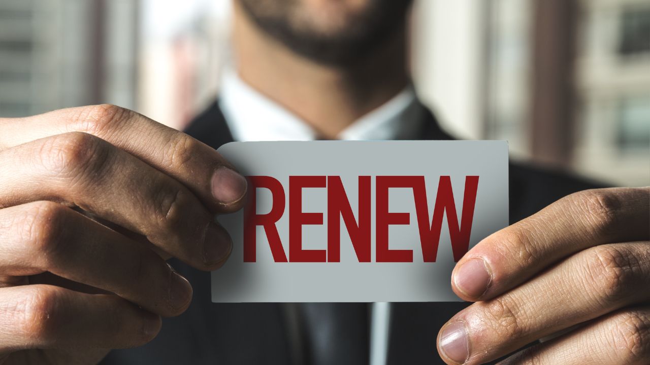 A man holding a renew card | Scott Legal, P.C. A man holding a renew card