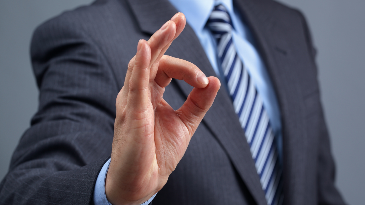 a business man signaling "ok" | Scott Legal, P.C. a business man signaling "ok"