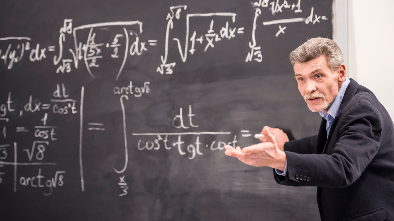 A professor teaching math on a board | Scott Legal, P.C. A professor teaching math on a board