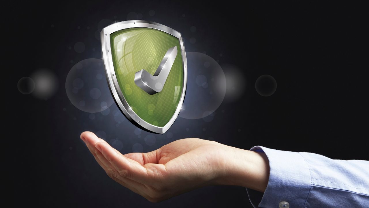 a hand holding a shield | Scott Legal, P.C. a hand holding a shield
