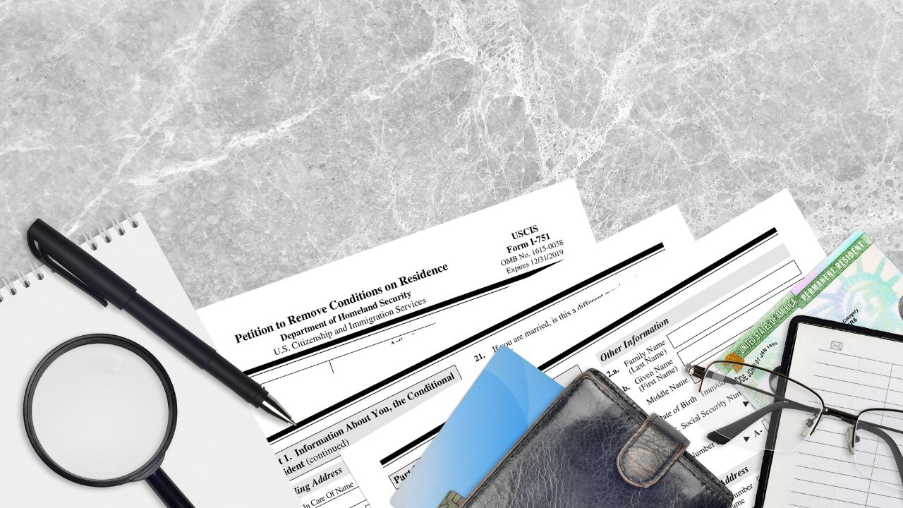 i751 form with a bunch of other immigration forms on a table | Scott Legal, P.C. i751 form with a bunch of other immigration forms on a table