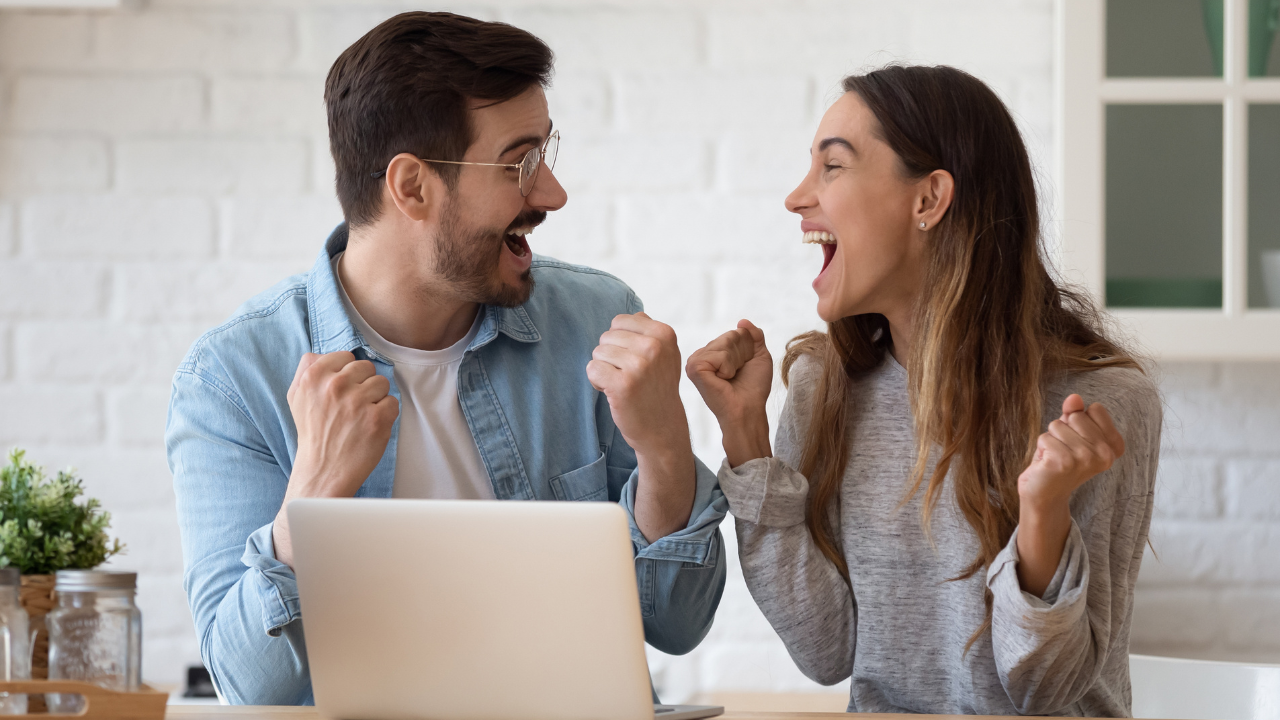 A couple celebrating good news | Scott Legal, P.C. A couple celebrating good news