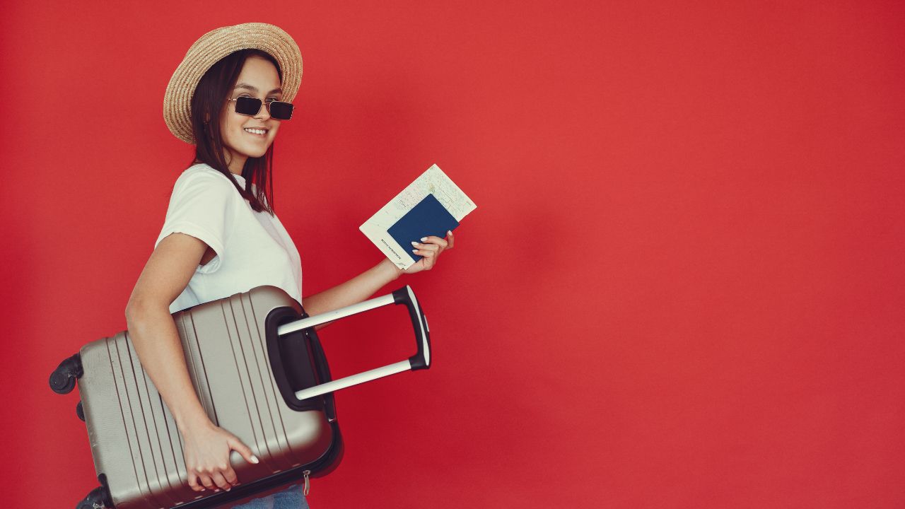 A woman getting ready to travel with her passport and suitcase | Scott Legal, P.C. A woman getting ready to travel with her passport and suitcase