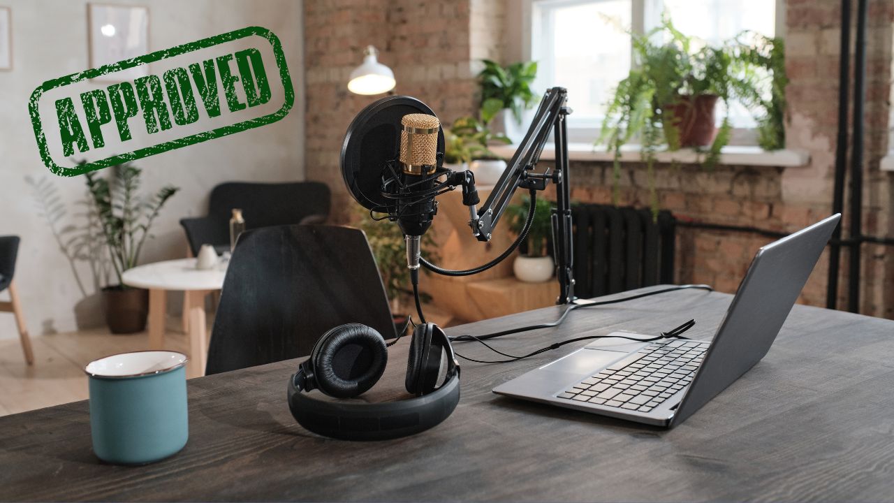 A podcast station set up with an approval stamp over it | Scott Legal, P.C. A podcast station set up with an approval stamp over it