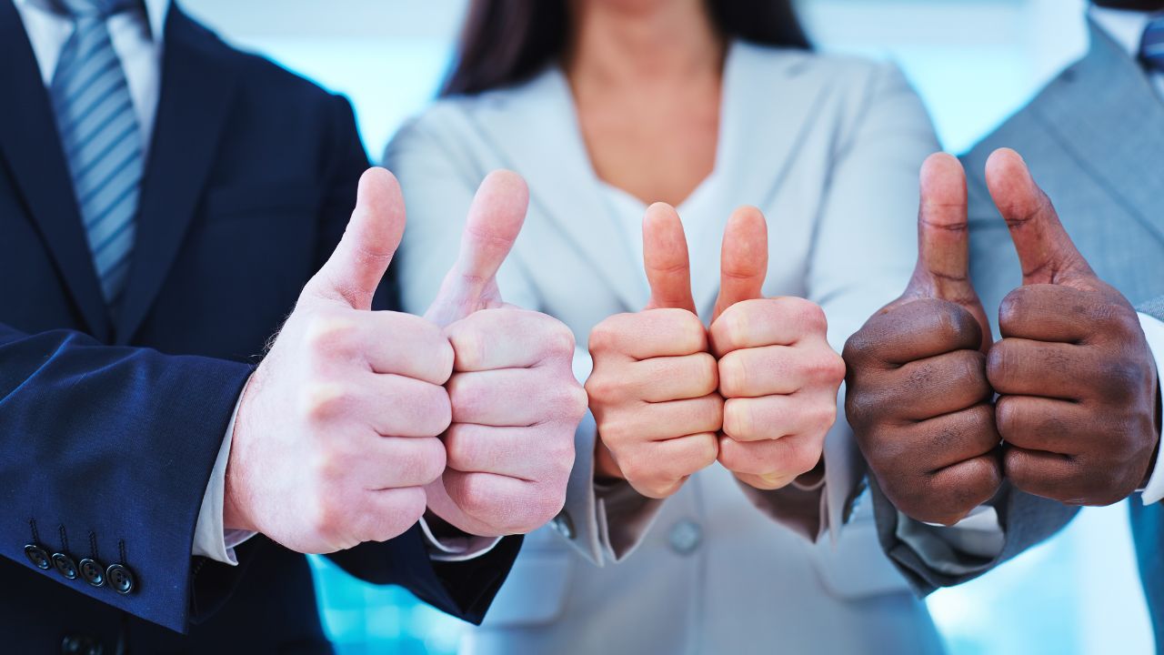 Three people doing thumbs up | Scott Legal, P.C. Three people doing thumbs up