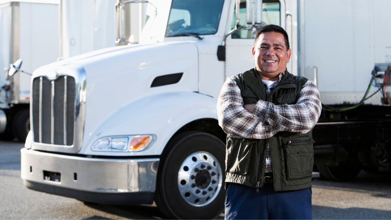 A truck driver standing with his truck | Scott Legal, P.C. A truck driver standing with his truck