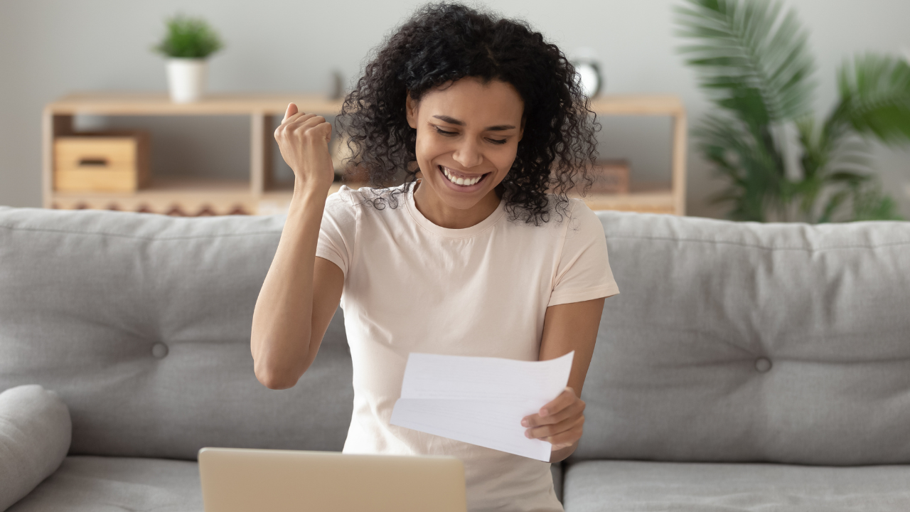 A woman celebrating a win and good news | Scott Legal, P.C. A woman celebrating a win and good news