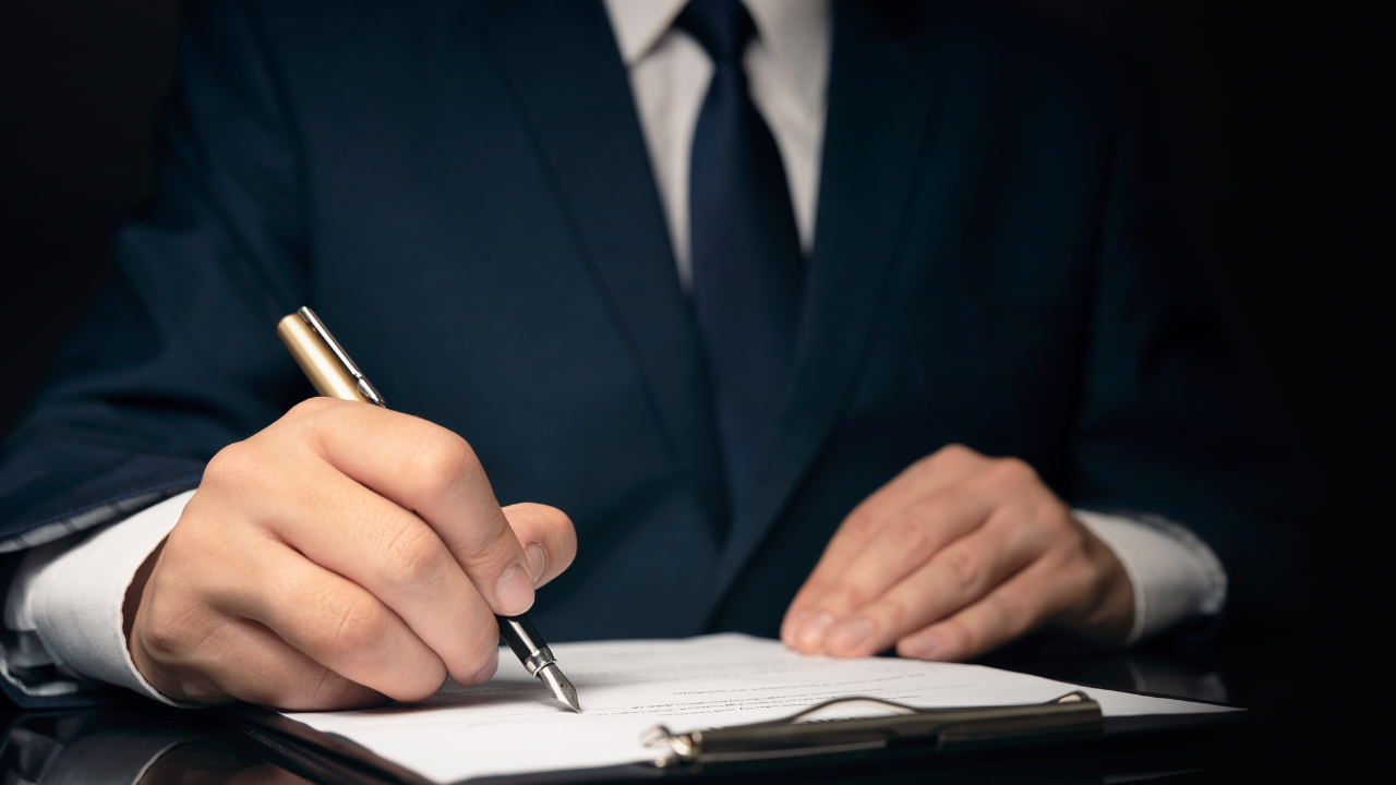 A business man taking notes | Scott Legal, P.C. A business man taking notes