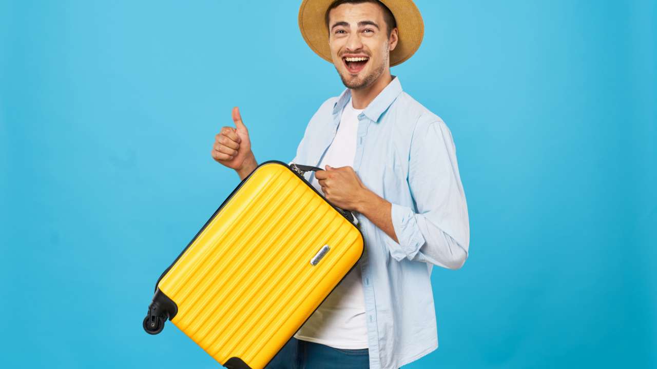 A man holding his suitcase and happy to travel | Scott Legal, P.C. A man holding his suitcase and happy to travel