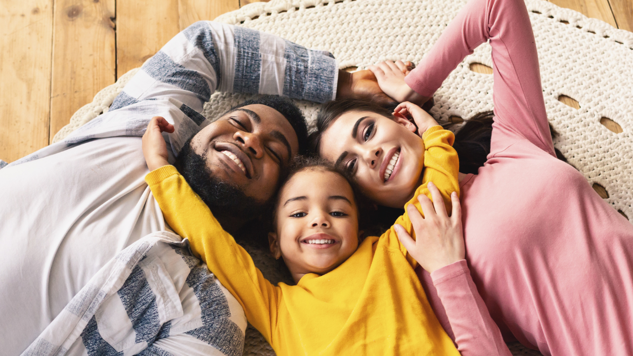 A happy family with parents and a child | Scott Legal, P.C. A happy family with parents and a child