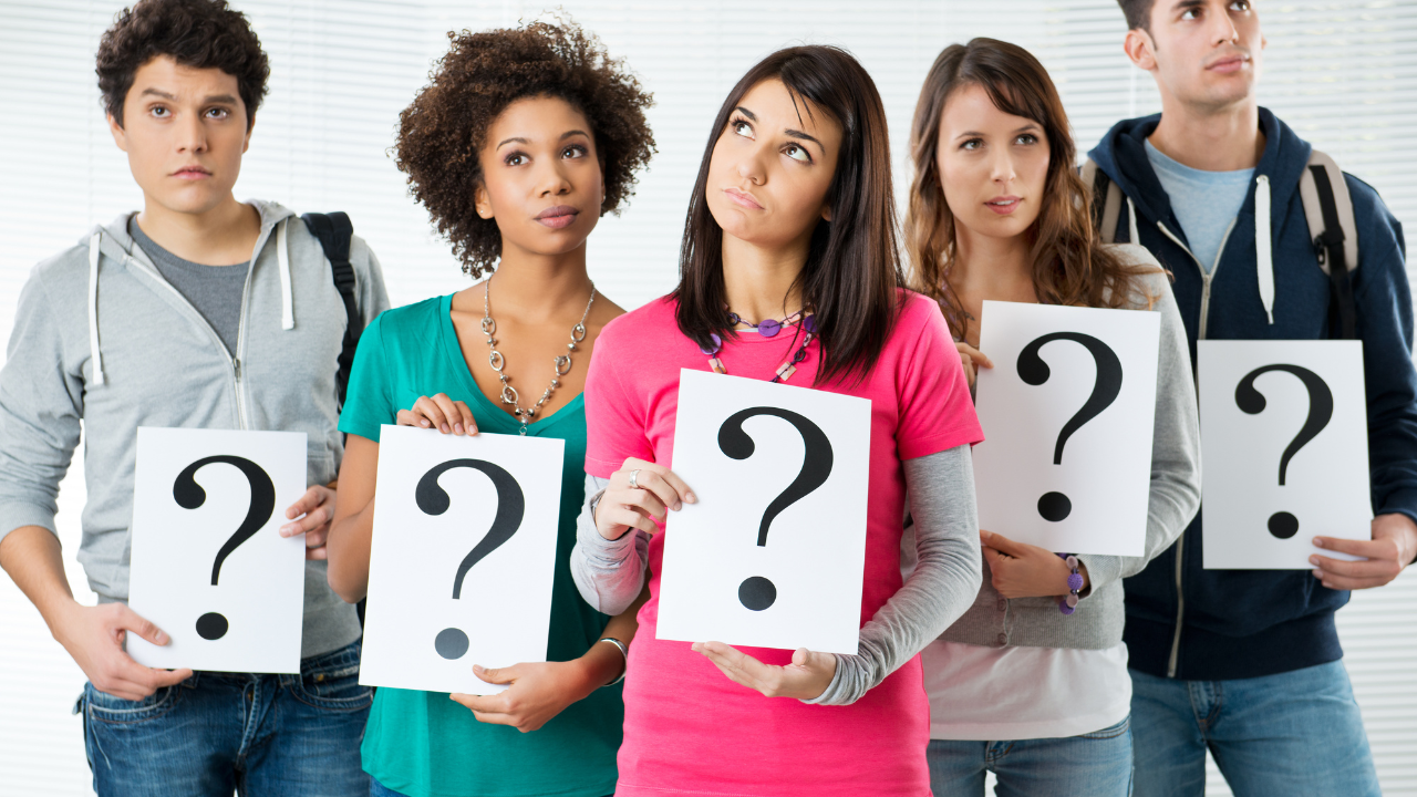 A group of people holding questions