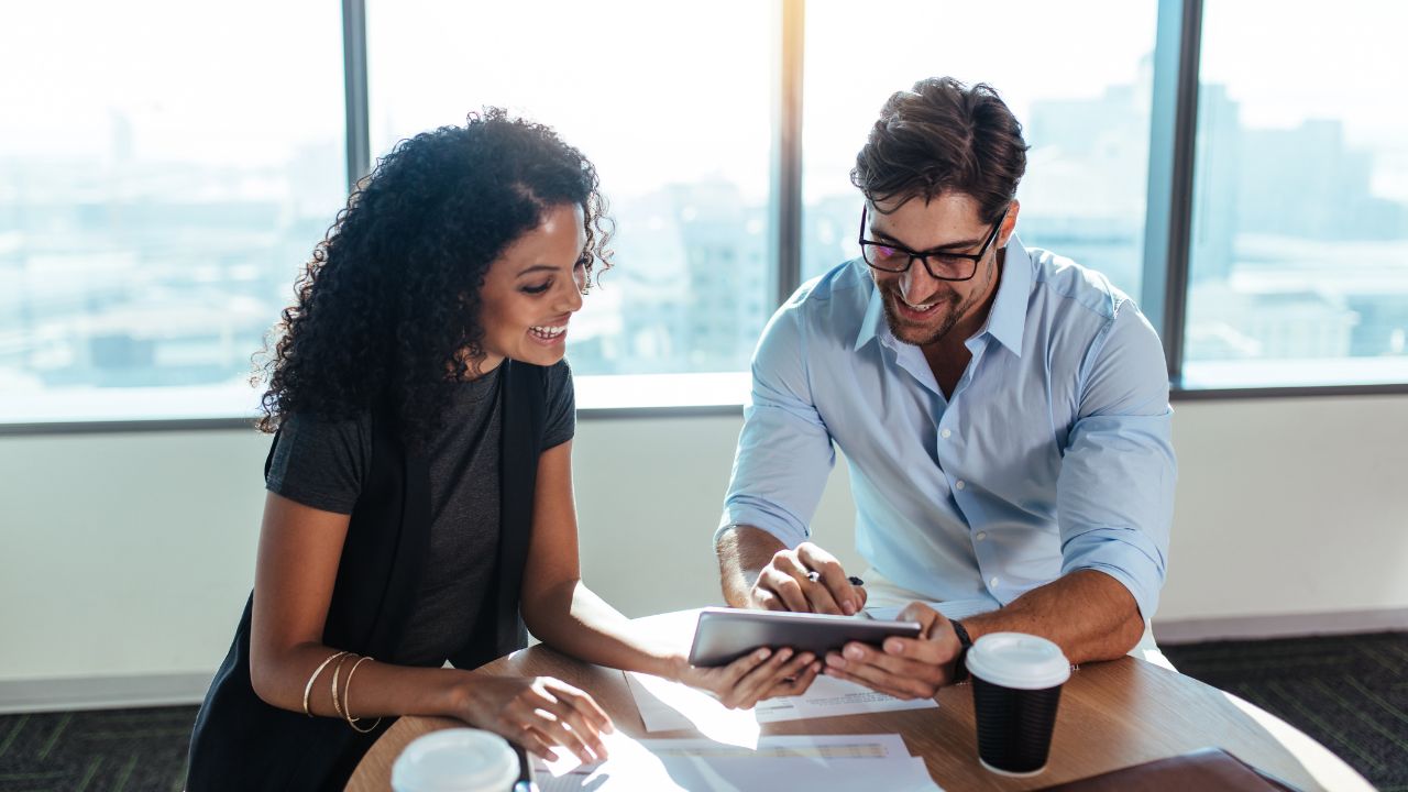 Co investors working together at a desk | Scott Legal, P.C. Co investors working together at a desk