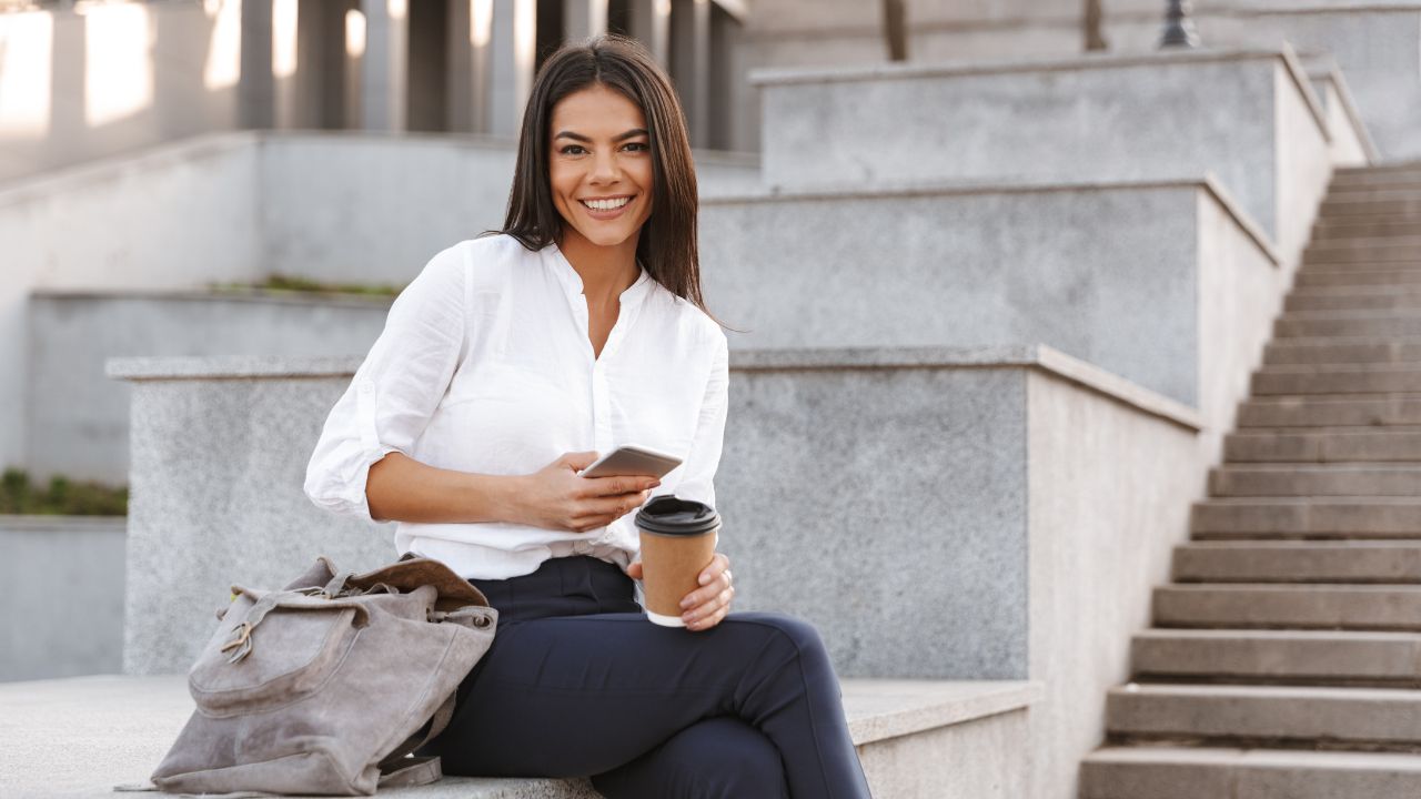A happy business owner sitting outside | Scott Legal, P.C. A happy business owner sitting outside