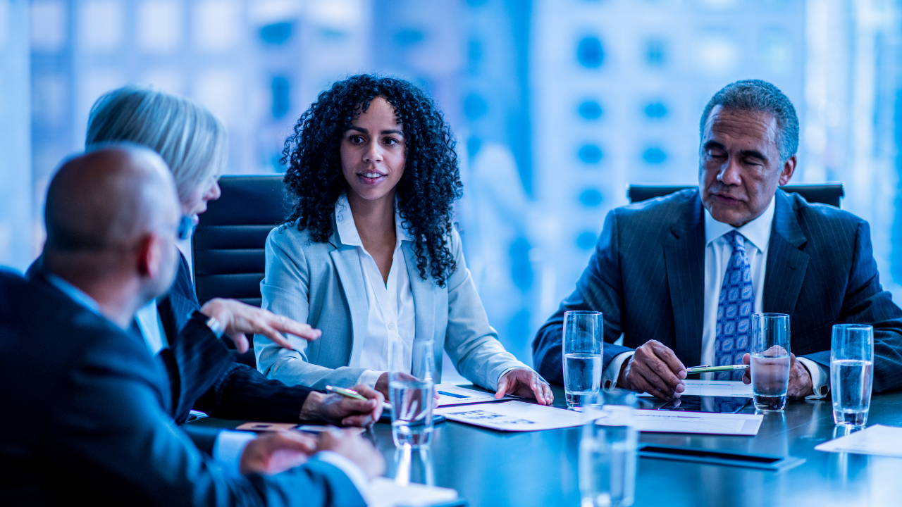 A group of executives in a board meeting | Scott Legal, P.C. A group of executives in a board meeting