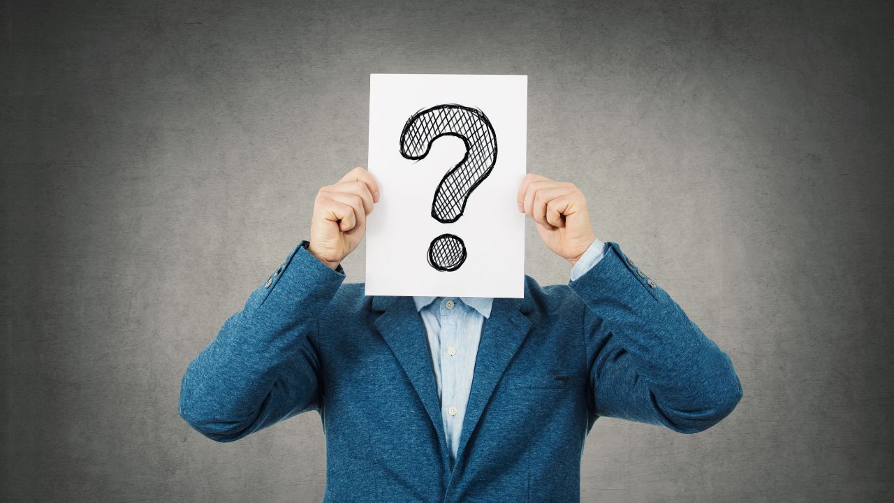 A man holding a question mark | Scott Legal, P.C. A man holding a question mark