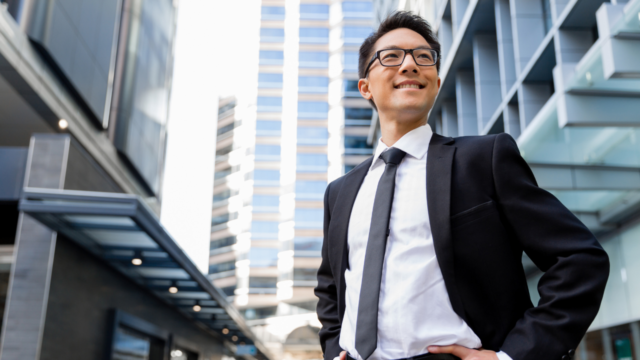 A business professional standing in a city