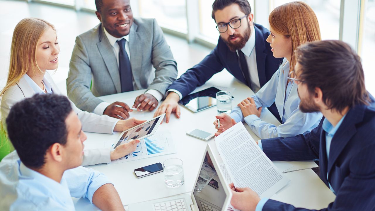 A group of employees in a meeting | Scott Legal, P.C. A group of employees in a meeting