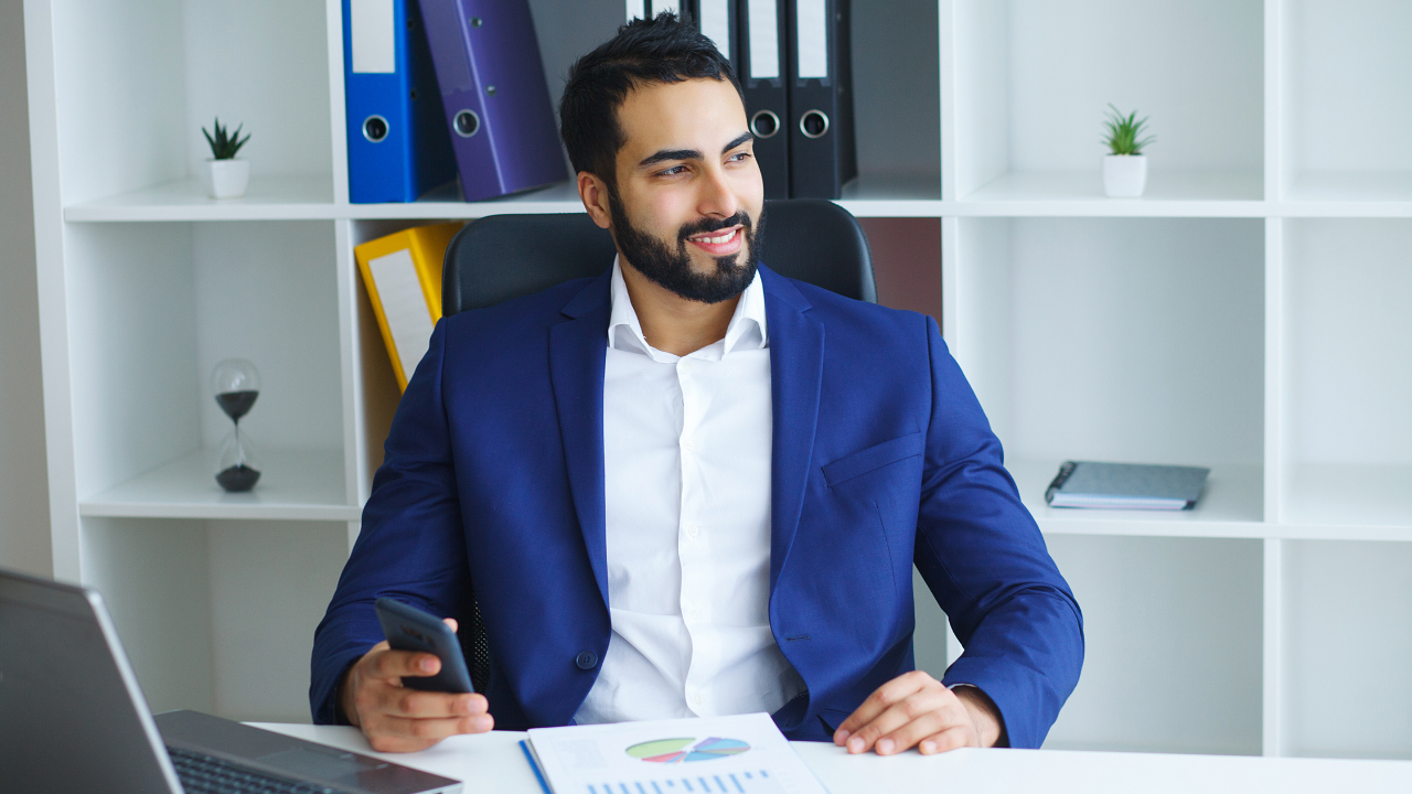 A self employed man sitting at his desk | Scott Legal, P.C. A self employed man sitting at his desk
