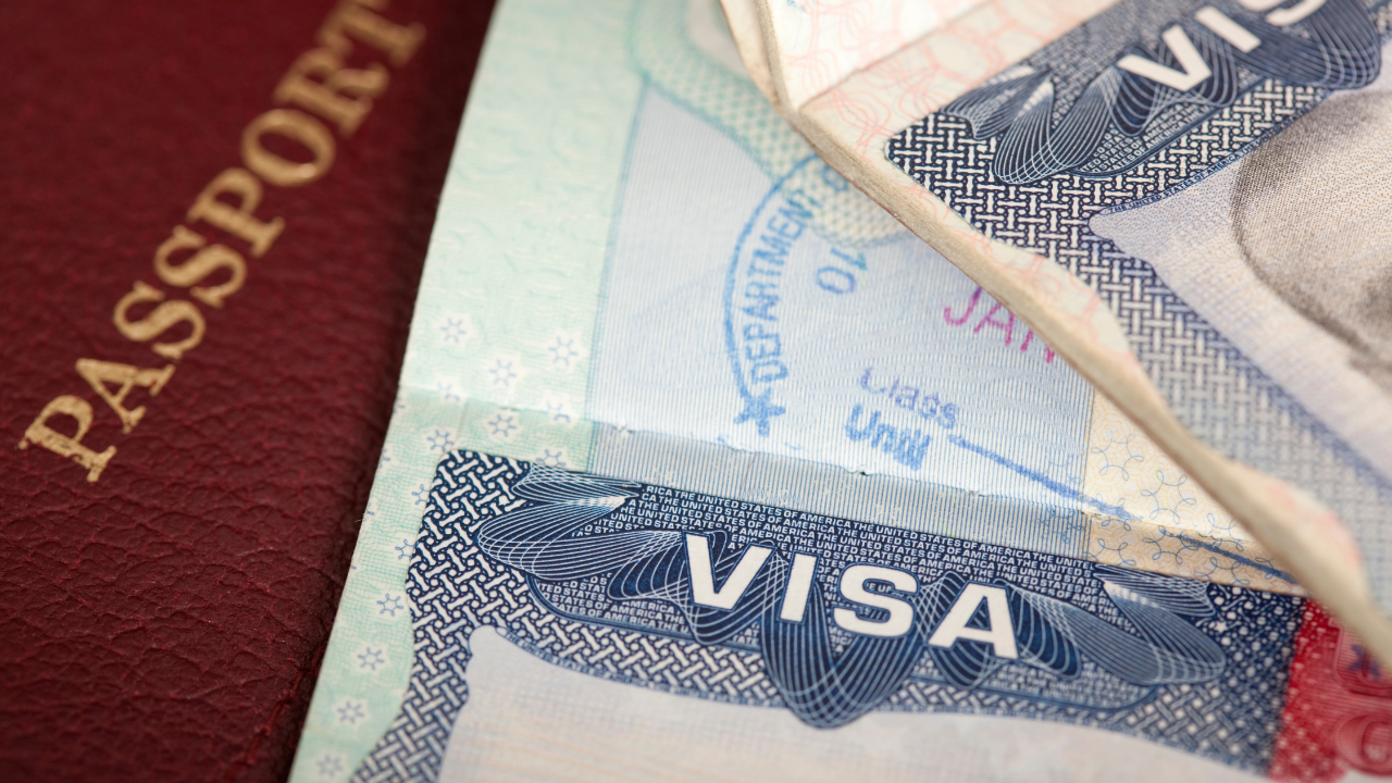 A passport and visa | Scott Legal, P.C. A passport and visa on a table