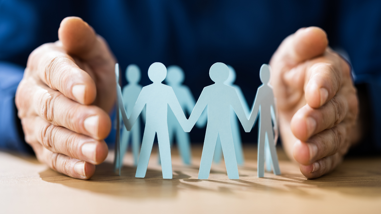 A hand protecting a group of people | Scott Legal, P.C. A hand protecting a group of people