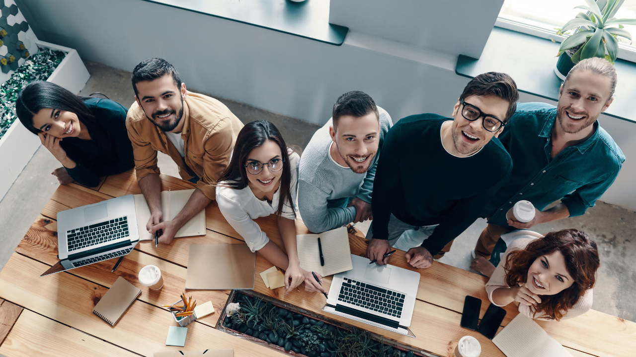 A business team in a meeting at a long desk | Scott Legal, P.C. A business team in a meeting at a long desk