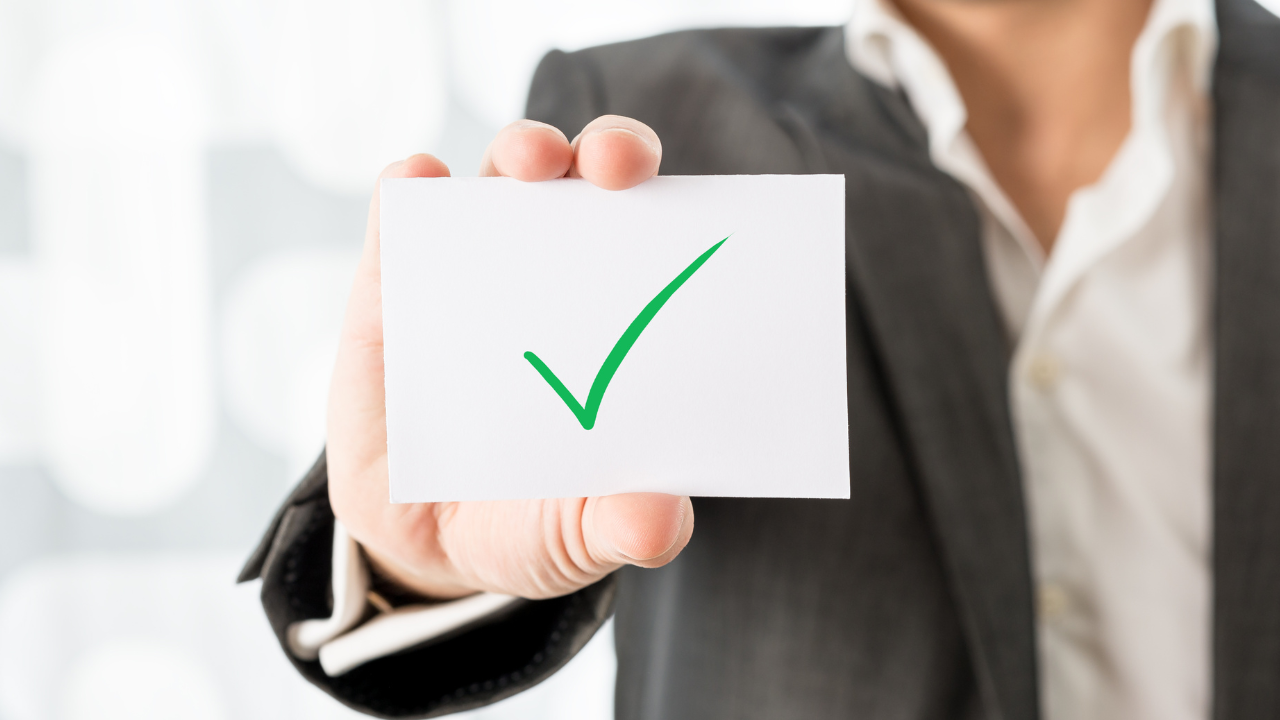 A professional holding a checkmark | Scott Legal, P.C. A professional holding a checkmark