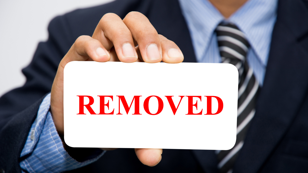 A business man holding a "removed" card | Scott Legal, P.C. A business man holding a "removed" card