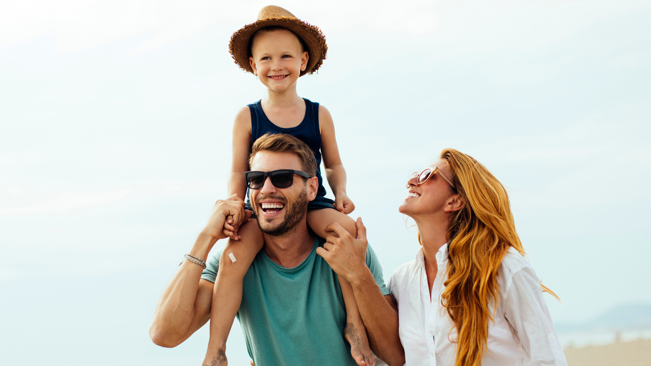 A happy family of 3 on vacation on the beach | Scott Legal, P.C. A happy family of 3 on vacation on the beach
