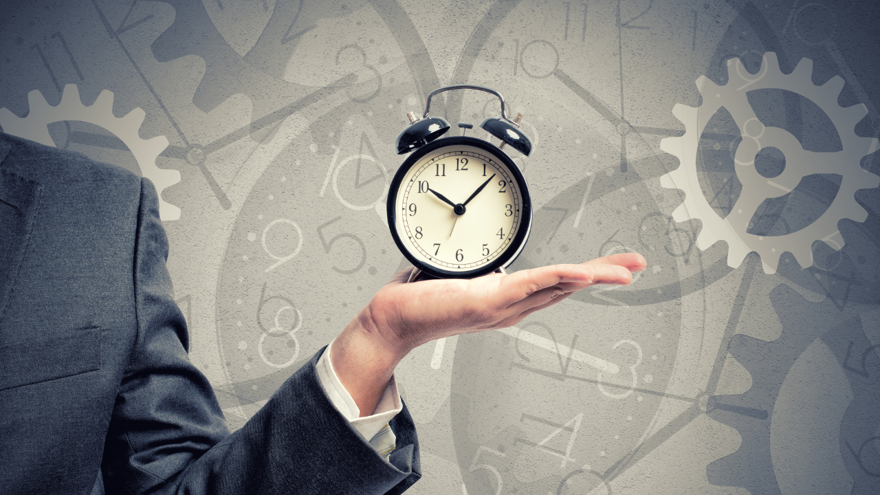 A man holding an alarm clock | Scott Legal, P.C. A man holding an alarm clock