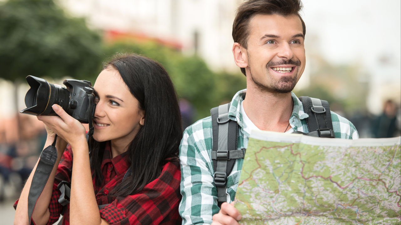 Two tourists with a camera and map | Scott Legal, P.C. Two tourists with a camera and map