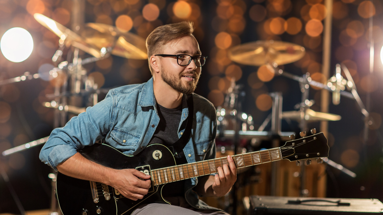 A musician playing guitar | Scott Legal, P.C. A musician playing guitar