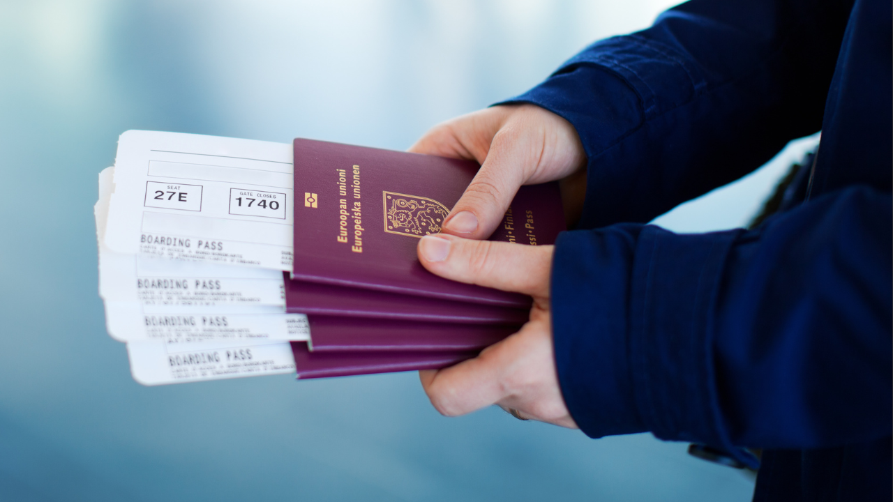 An individual holding a bunch of European passports and boarding passes | Scott Legal, P.C. An individual holding a bunch of European passports and boarding passes