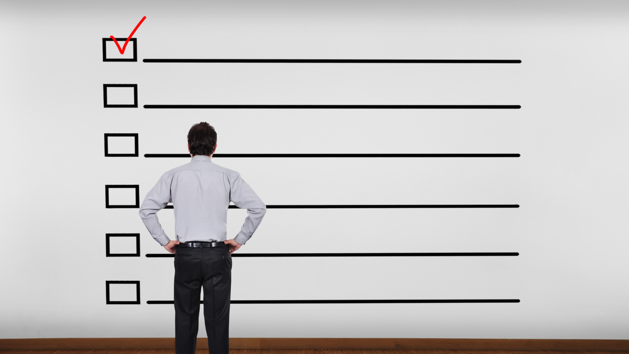 A man looking at a guide/checklist | Scott Legal, P.C. A man looking at a guide/checklist