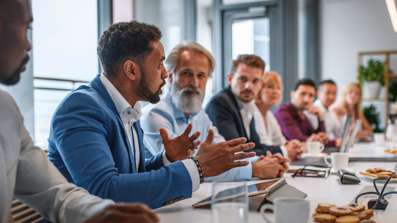 A group of executives and managers in a board meeting | Scott Legal, P.C. A group of executives and managers in a board meeting