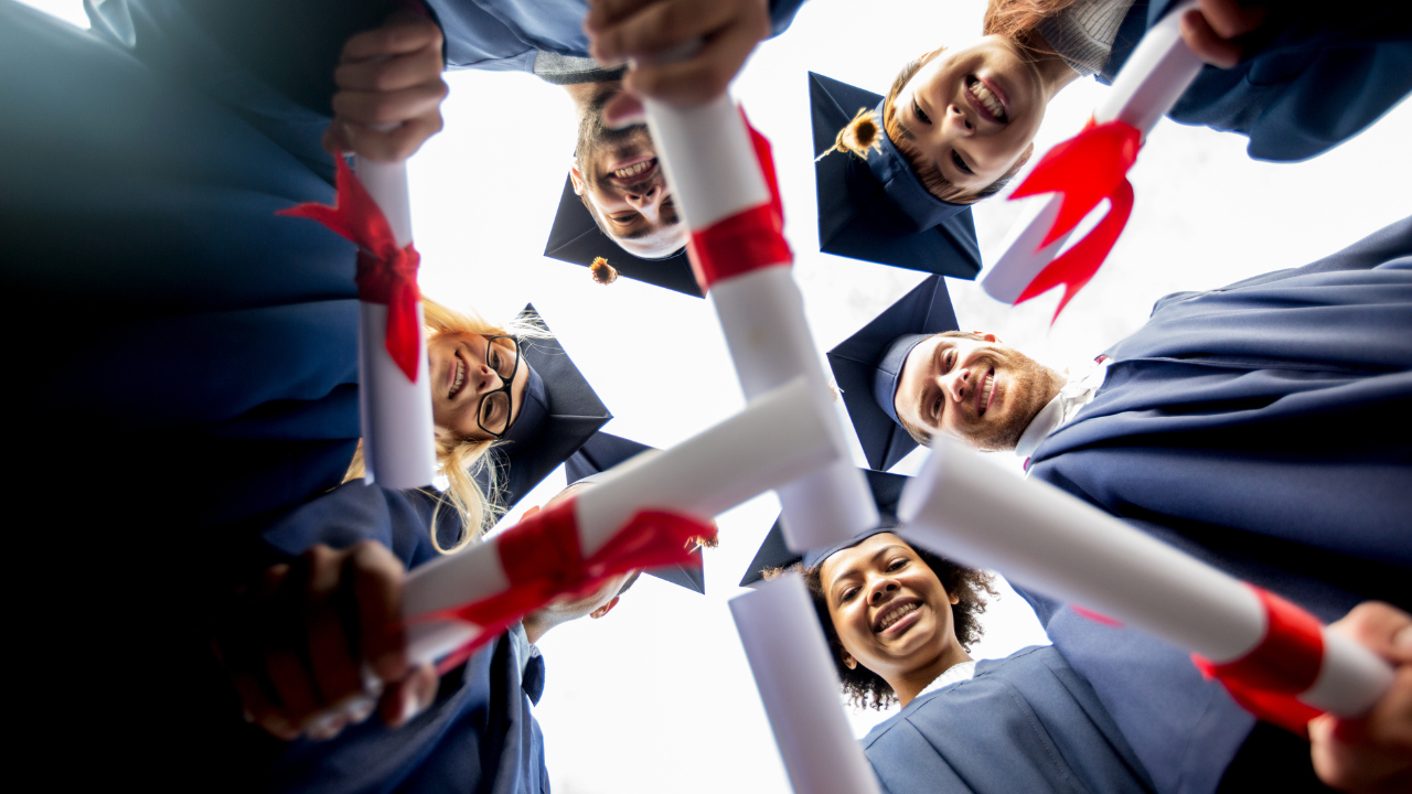 A group of graduates holding their bachelor degree | Scott Legal, P.C. A group of graduates holding their bachelor degree