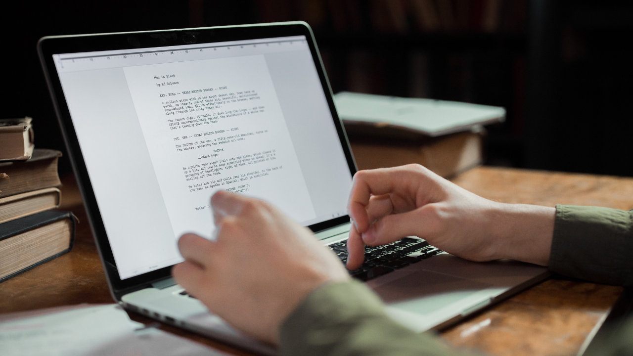 A writer working on a new project on their laptop | Scott Legal, P.C. A writer working on a new project on their laptop