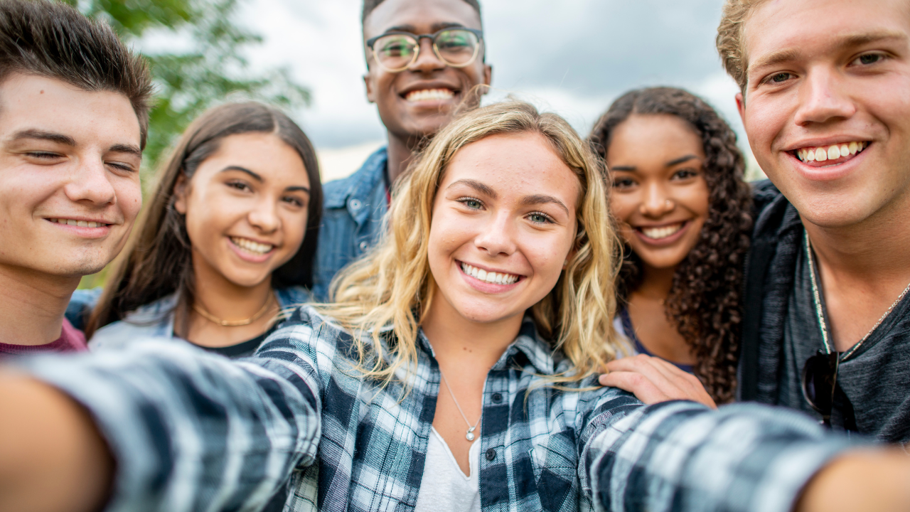 A group of teenage friends gathered together to take a photo | Scott Legal, P.C. A group of teenage friends gathered together to take a photo