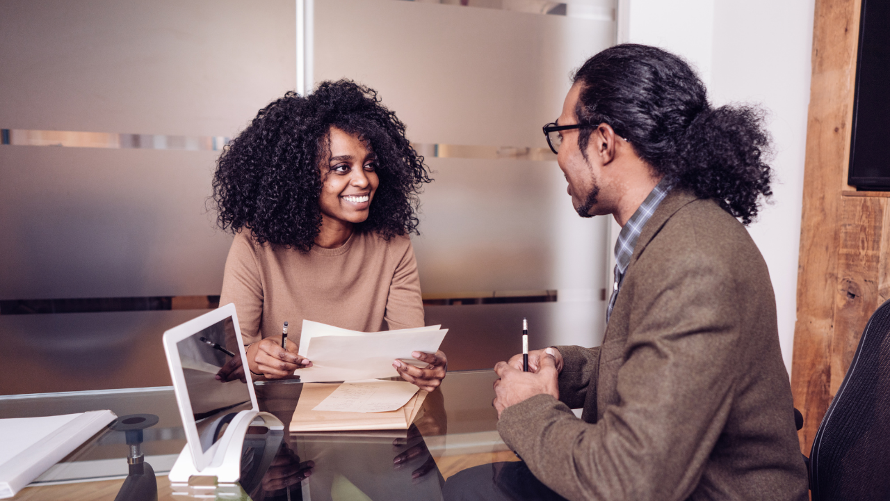 A woman conducting an interview with a man in her office | Scott Legal, P.C. A woman conducting an interview with a man in her office