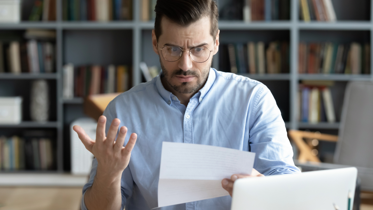 A man looking at a motion to dismiss with frustration | Scott Legal, P.C. A man looking at a motion to dismiss with frustration
