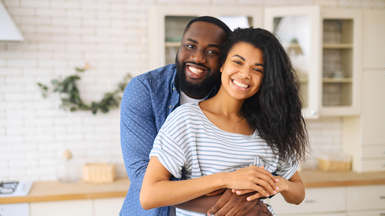 A married couple celebrating their new green cards | Scott Legal, P.C. A married couple celebrating their new green cards