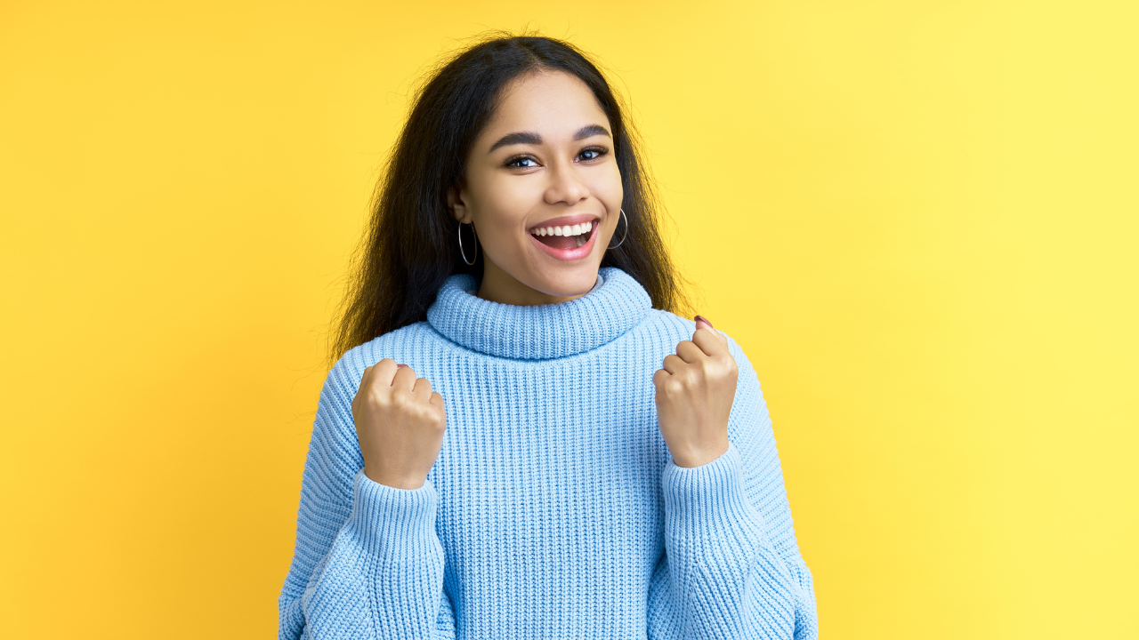 A woman celebrating a win | Scott Legal, P.C. A woman celebrating a win