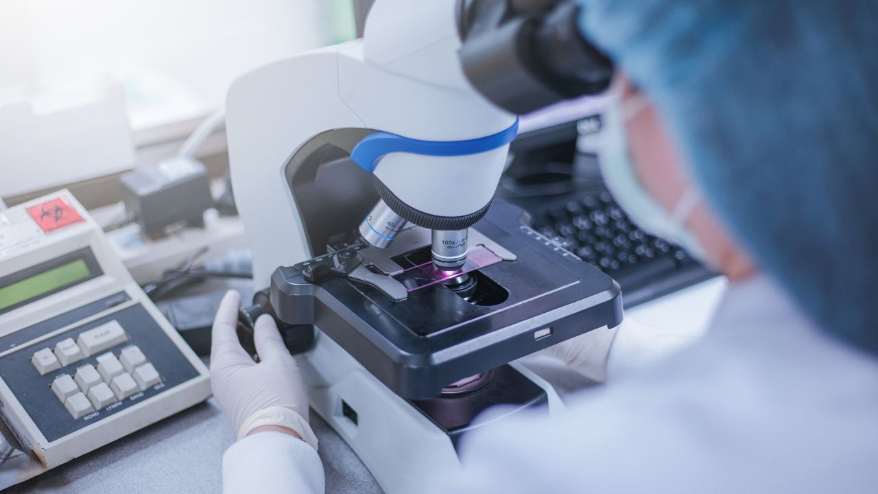 A researcher looking at something under a microscope | Scott Legal, P.C. A researcher looking at something under a microscope