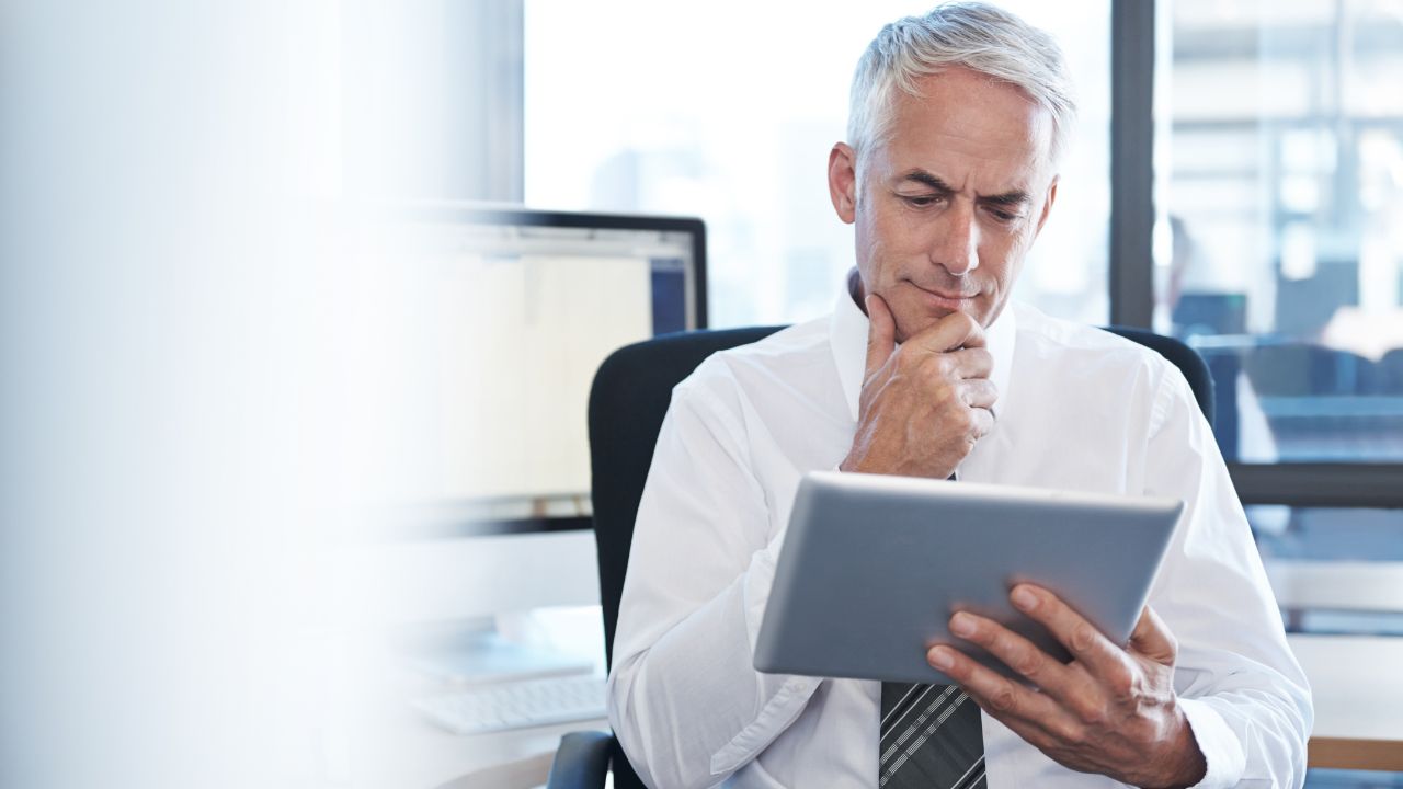 Entrepreneur looking at his options on a tablet | Scott Legal, P.C. Entrepreneur looking at his options on a tablet